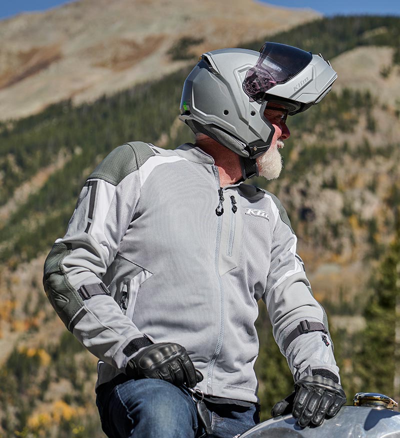 Guy wearing light grey Klim Induction Pro jacket